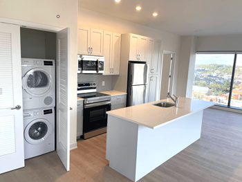 A modern kitchen with a view of the city.